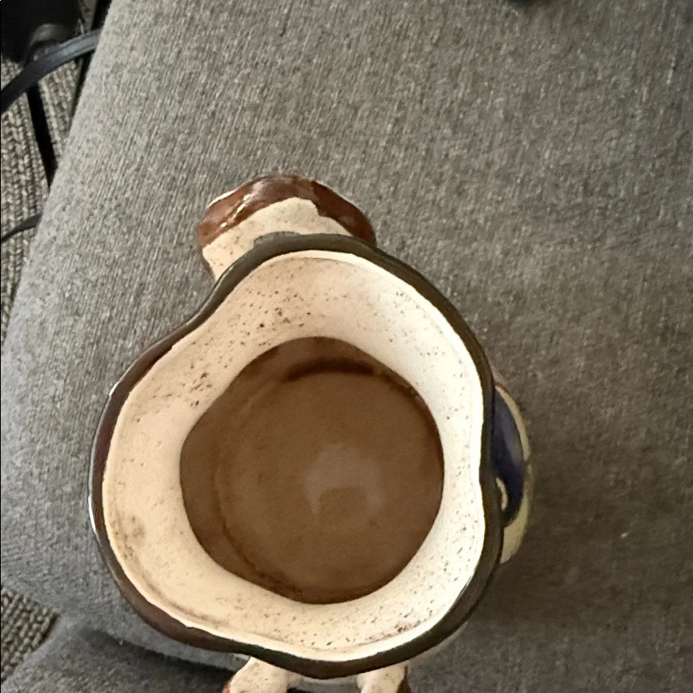 This is a vintage hand-painted ceramic pitcher 1976